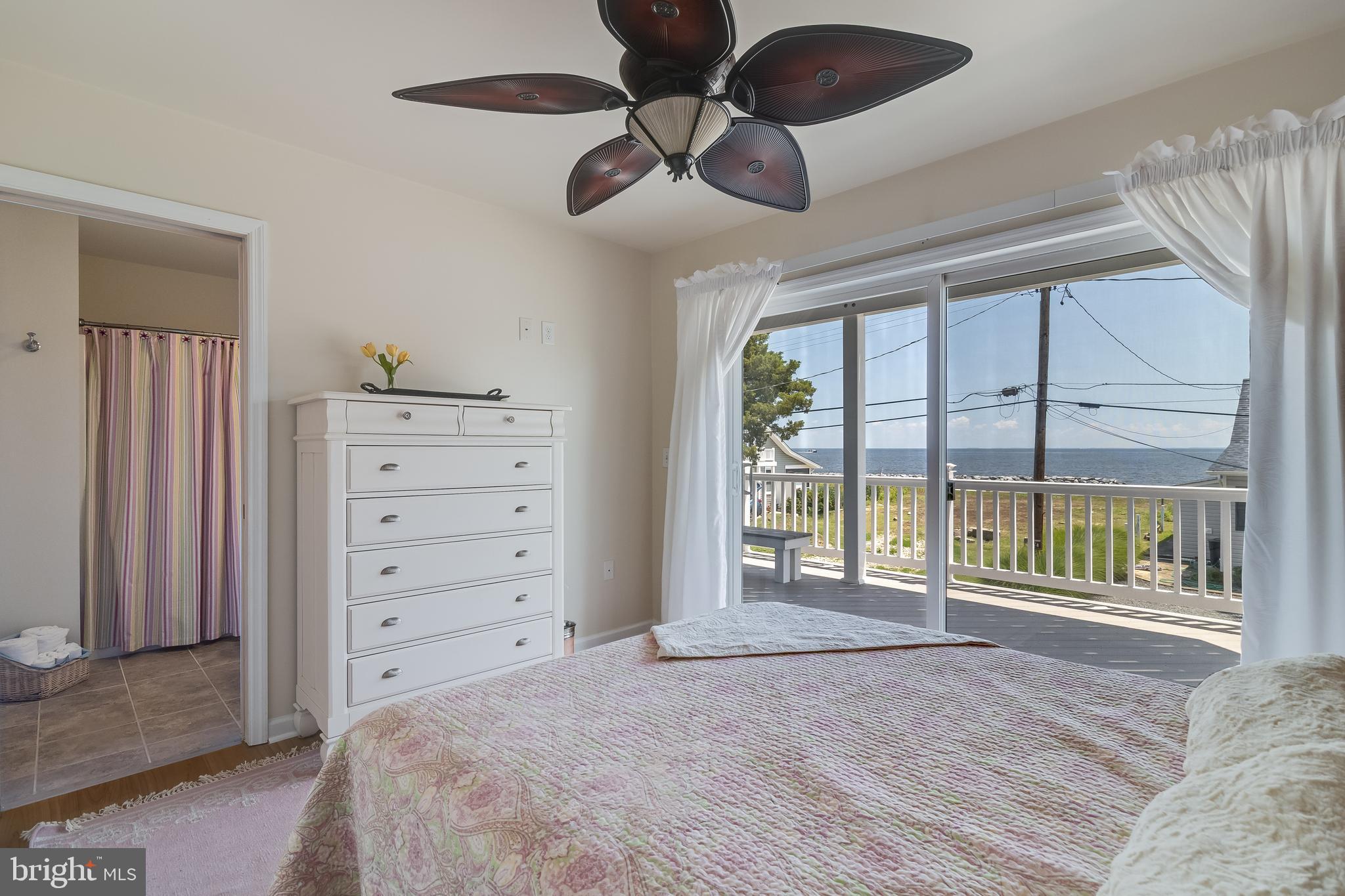 2818 Beach Drive Huntingtown, MD 20639 - Photo 34 of 74 a spacious bedroom with a large bed and a large window