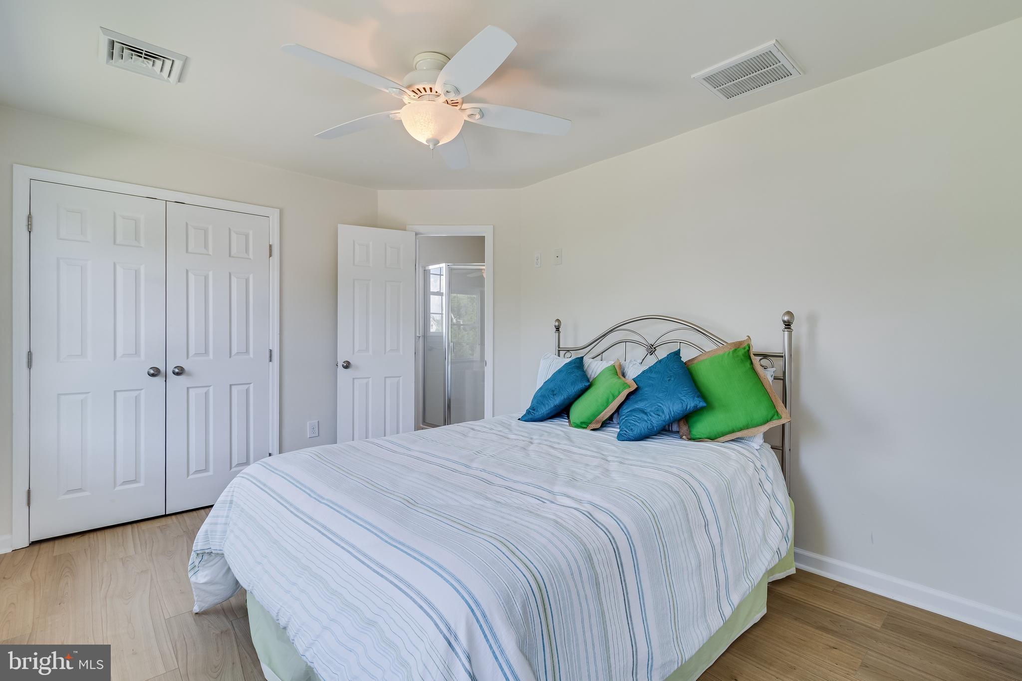 2818 Beach Drive Huntingtown, MD 20639 - Photo 35 of 74 a bedroom with a bed and a chandelier