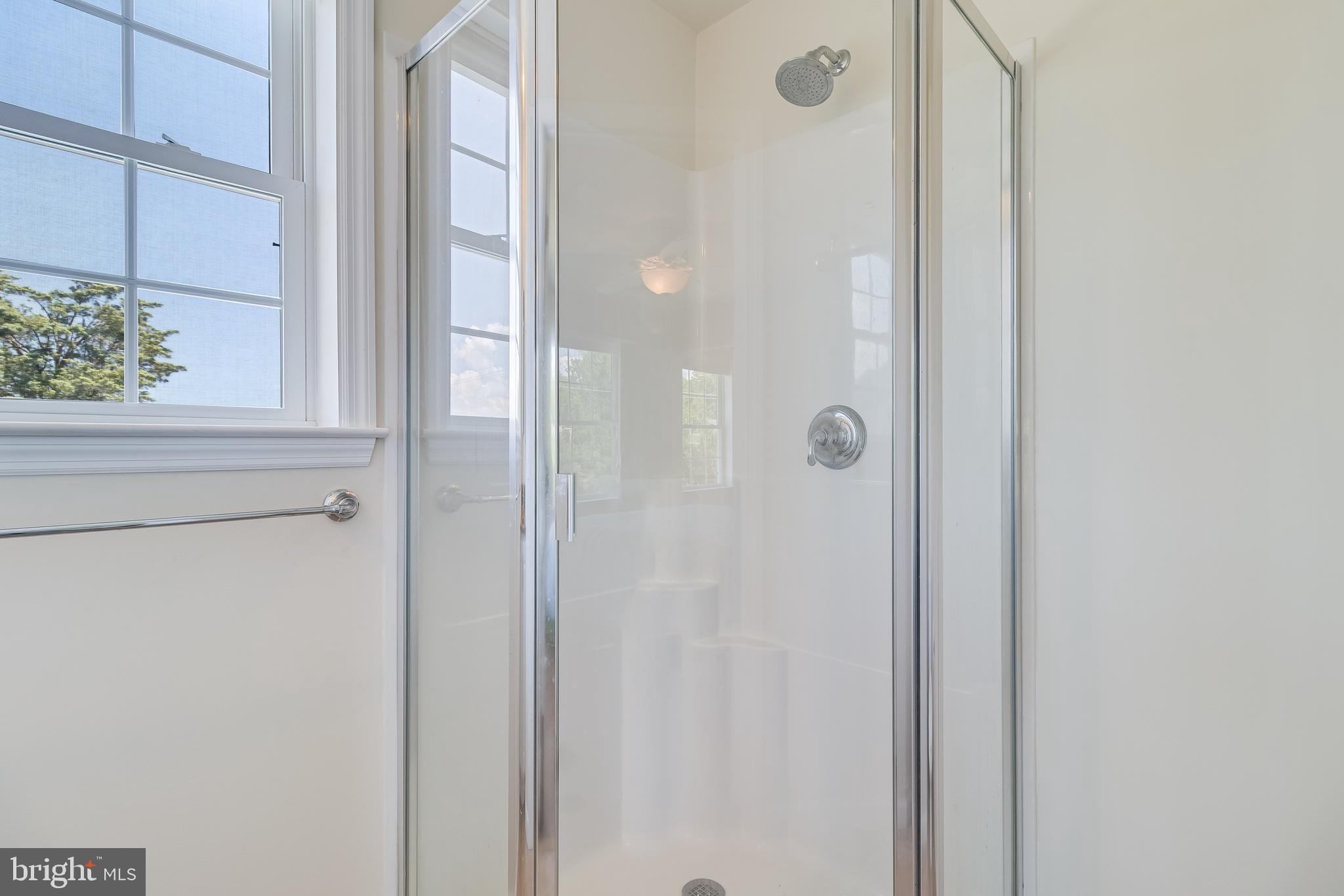 2818 Beach Drive Huntingtown, MD 20639 - Photo 36 of 74 a bathroom with a glass shower door