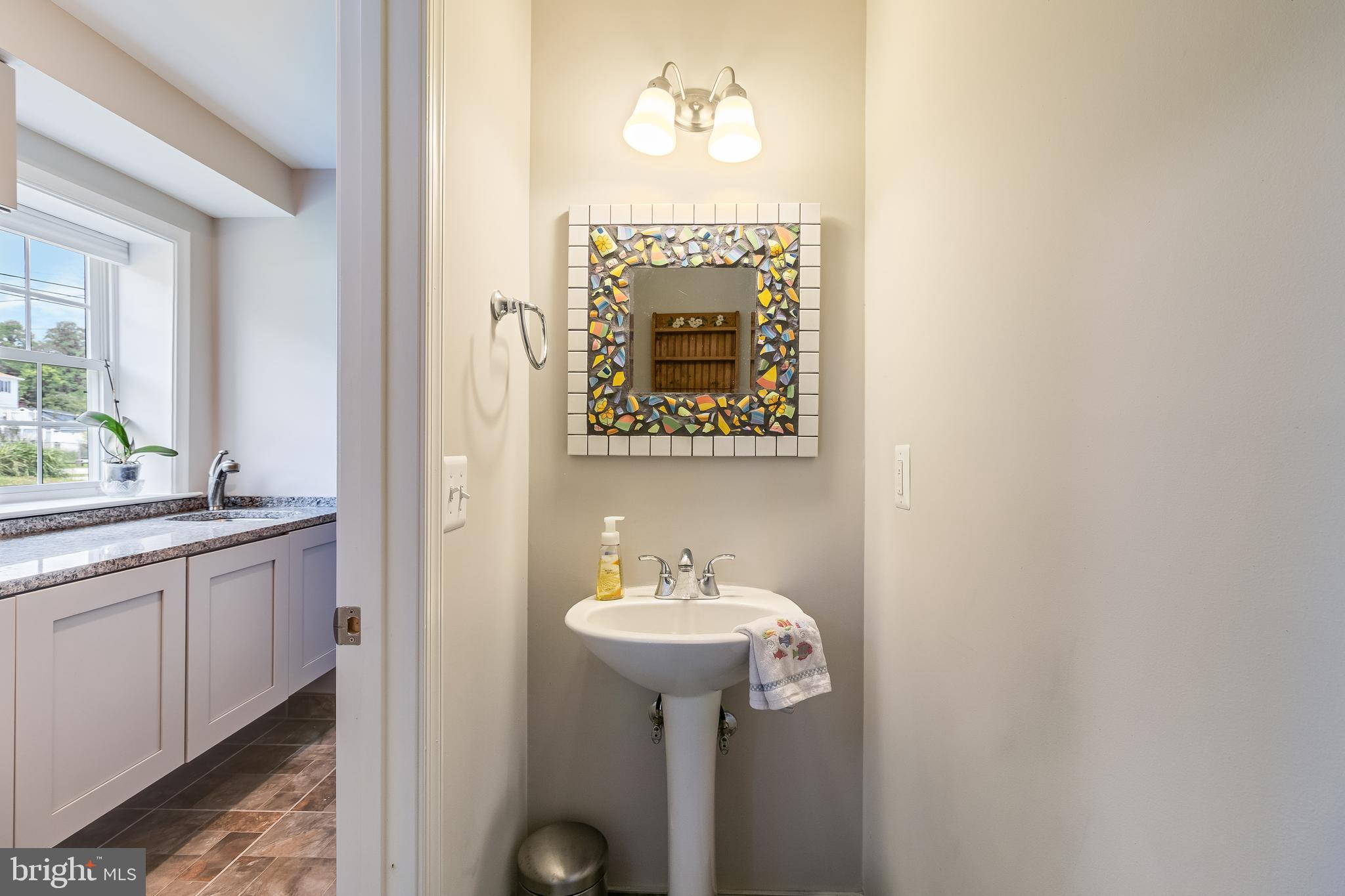 2818 Beach Drive Huntingtown, MD 20639 - Photo 47 of 74 a bathroom with a sink and a mirror