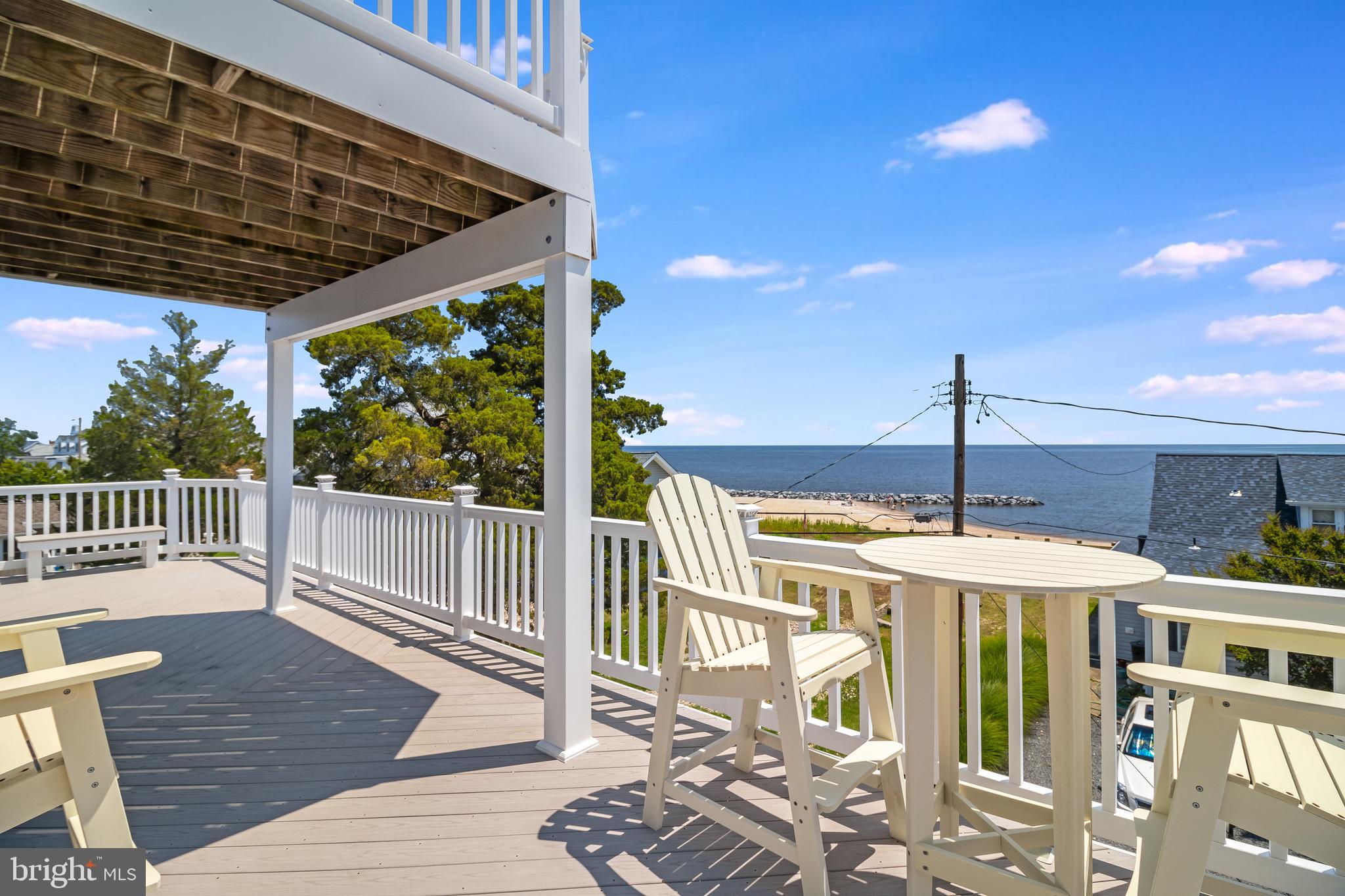 2818 Beach Drive Huntingtown, MD 20639 - Photo 54 of 74 a view of a patio with a table chairs and wooden floor