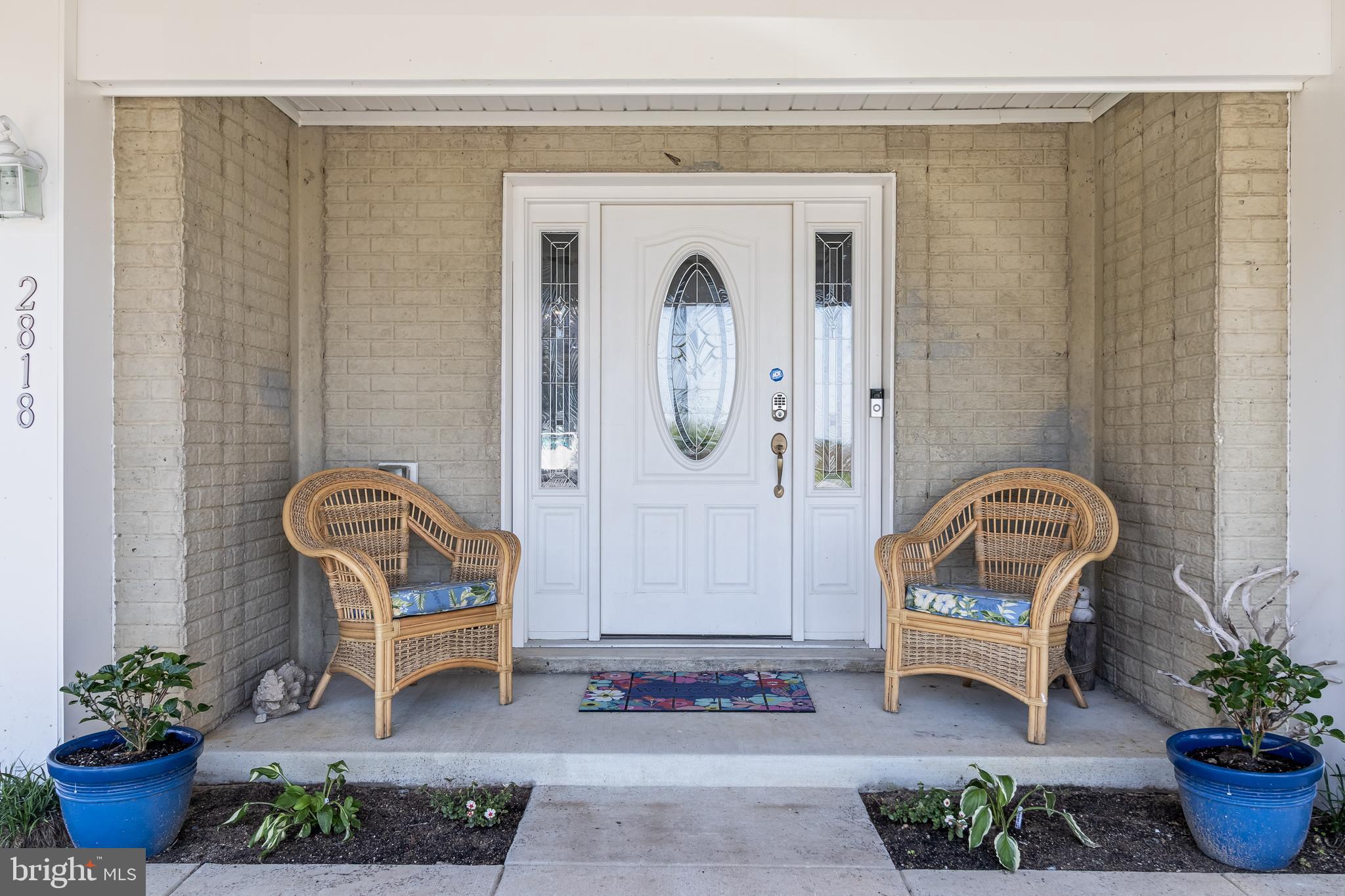 2818 Beach Drive Huntingtown, MD 20639 - Photo 55 of 74 a front view of a house with outdoor seating and plants