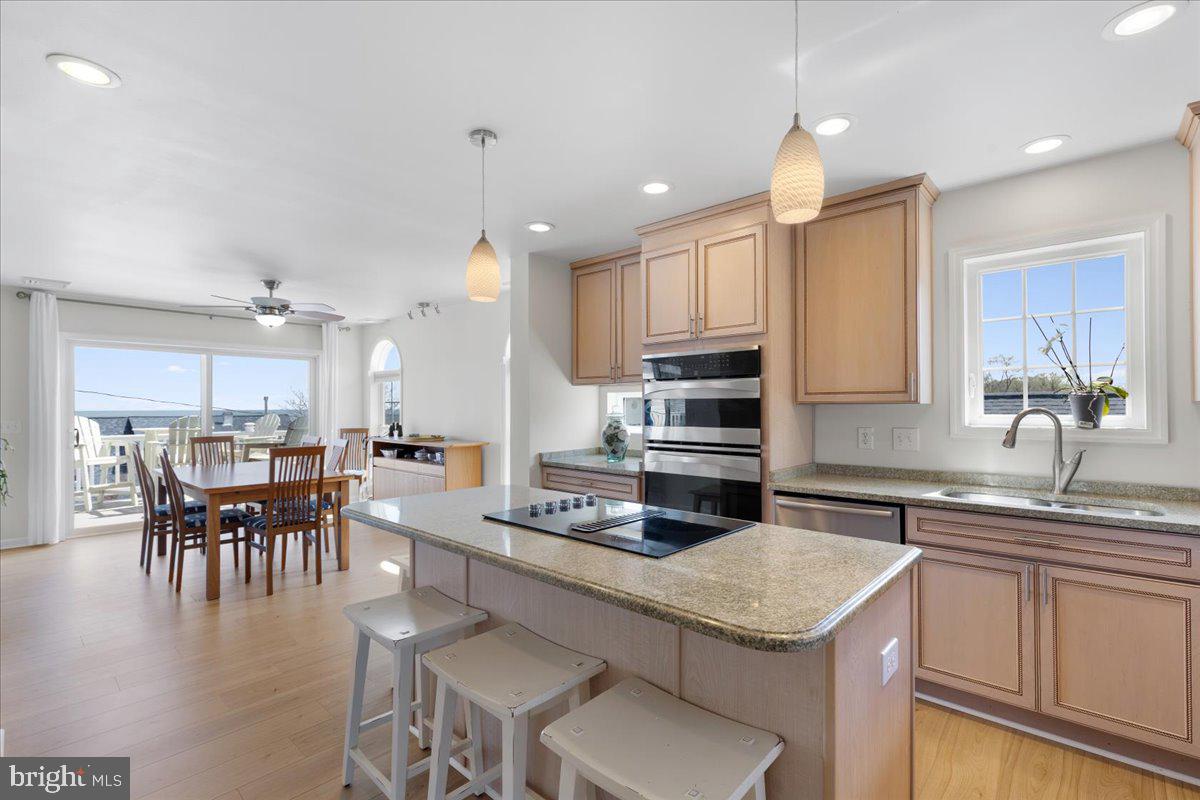 2818 Beach Drive Huntingtown, MD 20639 - Photo 6 of 74 a kitchen with a table chairs sink and cabinets