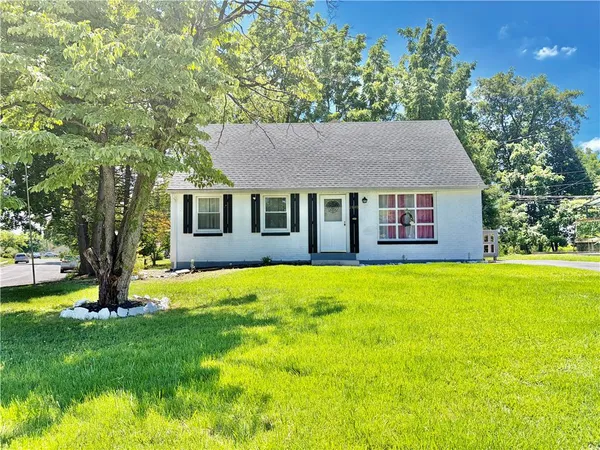 a house that is sitting in the grass