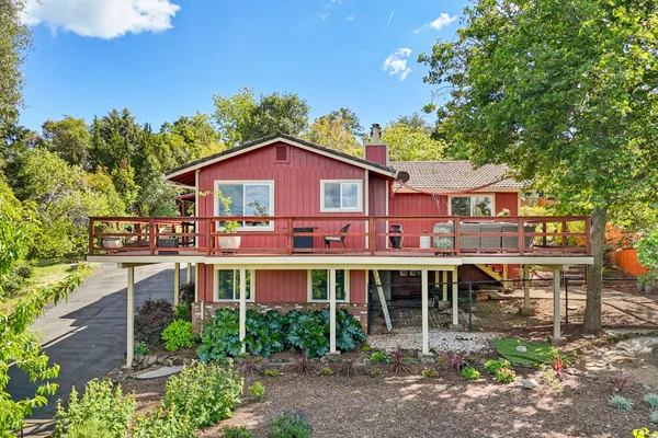 a front view of a house with a yard table and chairs