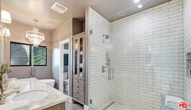 a bedroom with bed and a potted plant