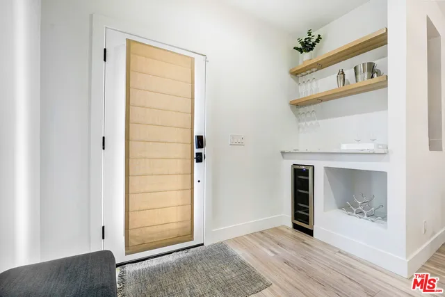 a living room with furniture a flat screen tv and a window