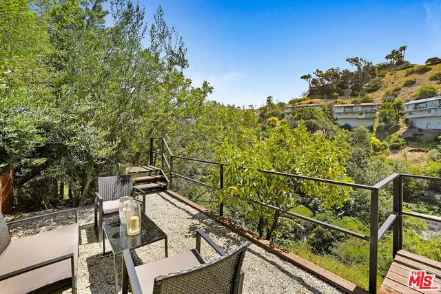 a view of a balcony with wooden floor and fence