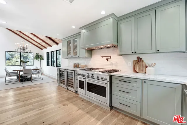 a kitchen with cabinets and wooden floor