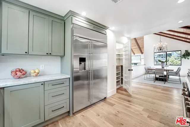 a spacious bedroom with a large bed a fireplace and a couch