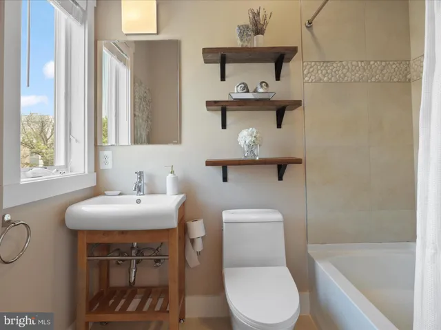 a bedroom with a bed a mirror and a window