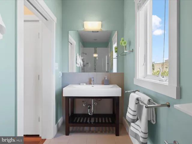 a view of a patio with couches table and chairs and potted plants