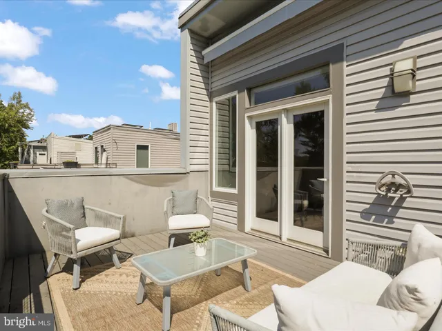 a view of a balcony with a floor to ceiling window and wooden floor