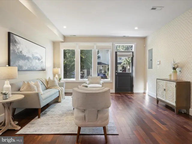 a dining room with wooden floor a chandelier a wooden table and chairs