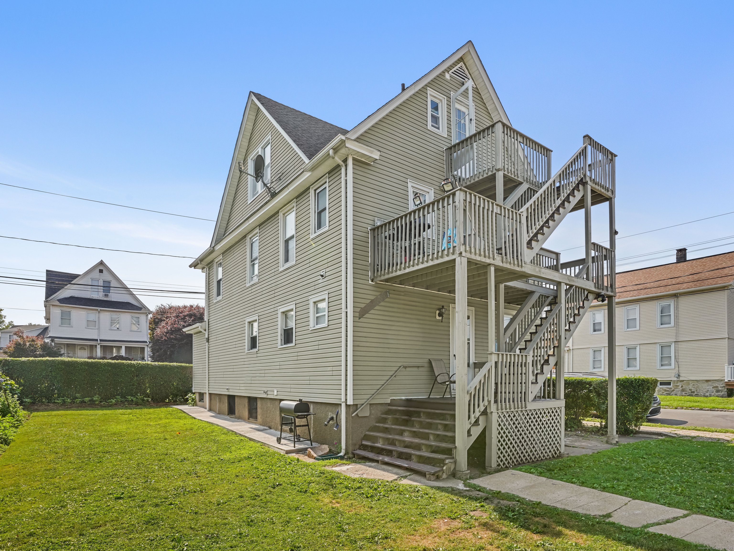 90 Amsterdam Avenue, Unit 1 Bridgeport, CT 06606 - Photo 13 of 14 a front view of a house with a yard