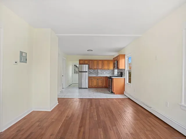a view of a kitchen with wooden floor