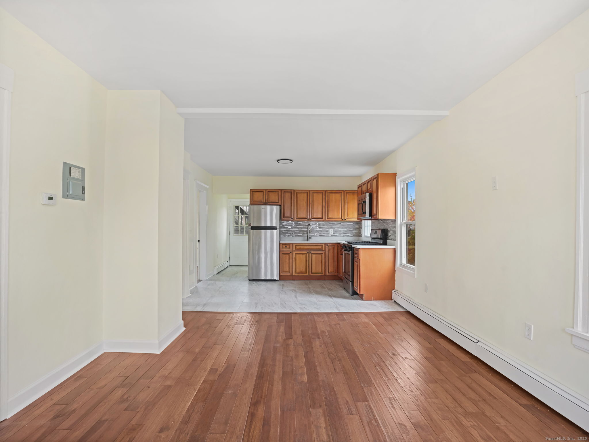 90 Amsterdam Avenue, Unit 1 Bridgeport, CT 06606 - Photo 3 of 14 a view of a kitchen with wooden floor
