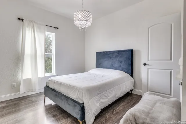 a bedroom with bed and window