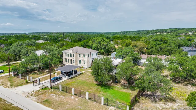 an aerial view of a house with swimming pool and garden