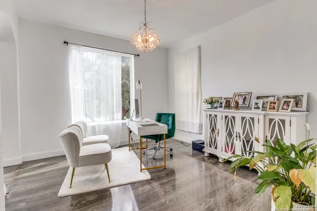 a living room with furniture and a chandelier
