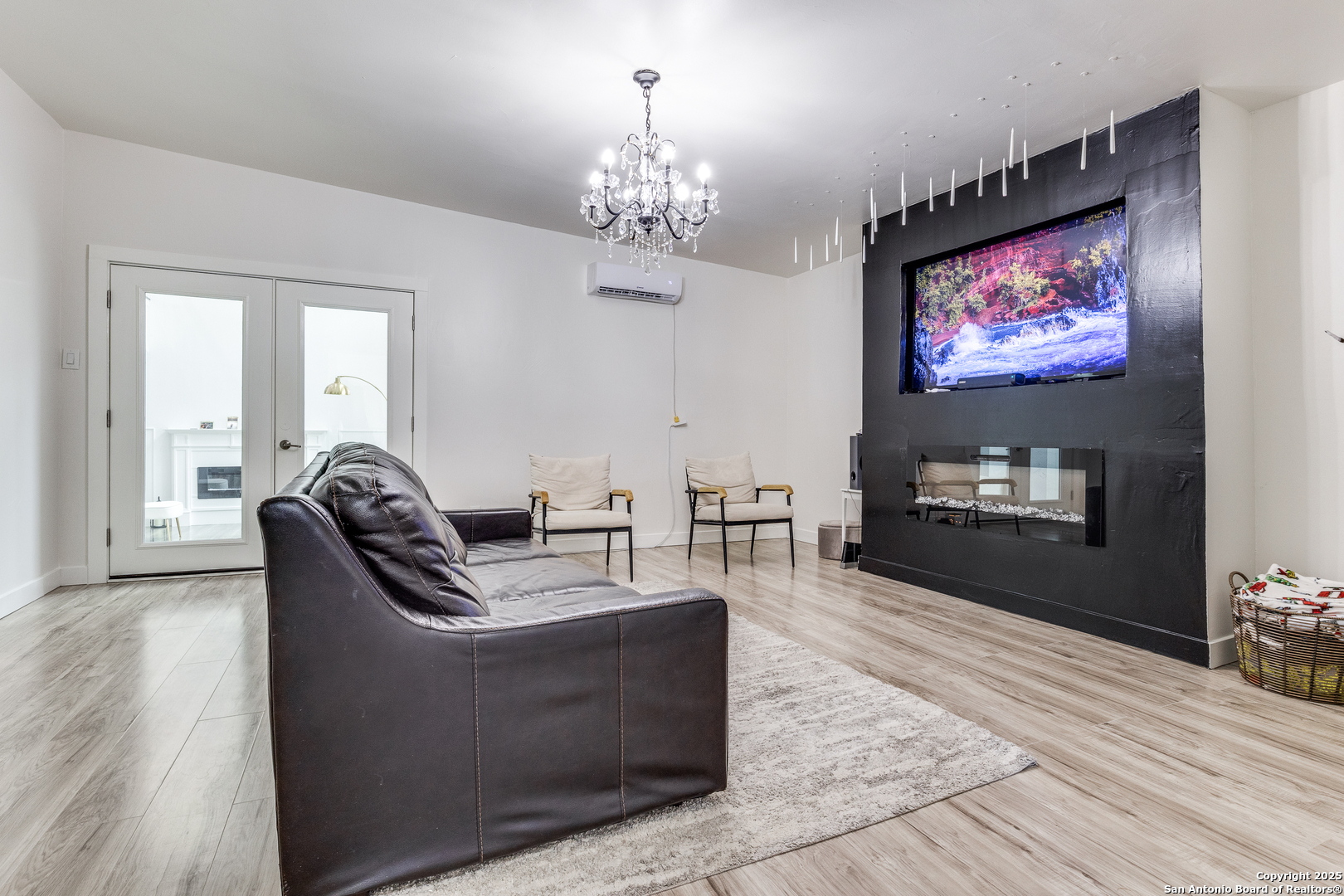 1071 Hidden Valley Drive Spring Branch, TX 78070 - Photo 9 of 30 a living room with furniture a chandelier and a flat screen tv