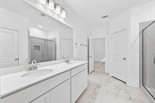 a bathroom with a double vanity sink mirror and double