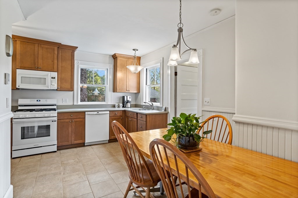 256 Great Road Stow, MA 01775 - Photo 11 of 42 a kitchen with a table chairs and a stove