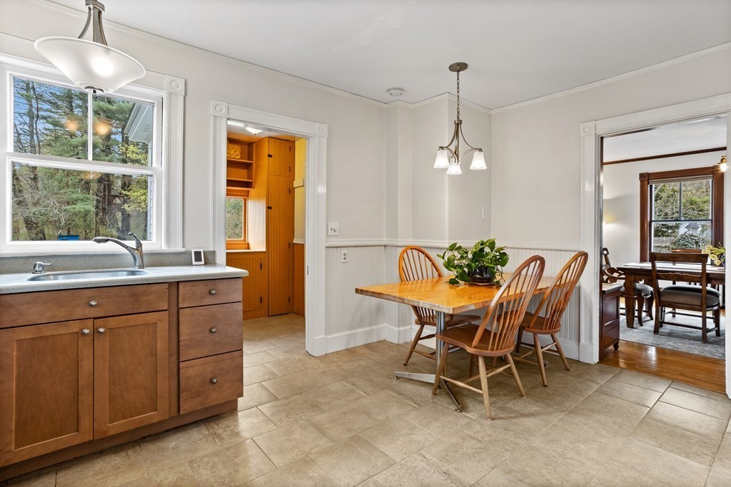 256 Great Road Stow, MA 01775 - Photo 12 of 42 a dining room with furniture a chandelier and window