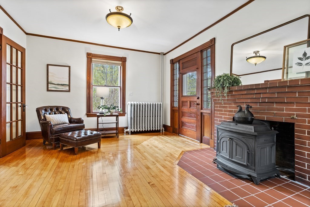256 Great Road Stow, MA 01775 - Photo 21 of 42 a living room with furniture stove and a fireplace