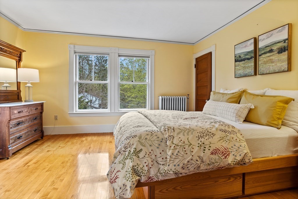 256 Great Road Stow, MA 01775 - Photo 25 of 42 a bed sitting in a bedroom next to a window