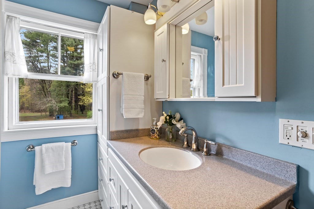 256 Great Road Stow, MA 01775 - Photo 28 of 42 a bathroom with a sink vanity and a mirror