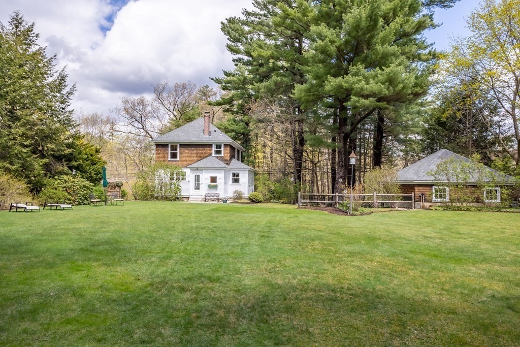 256 Great Road Stow, MA 01775 - Photo 33 of 42 a view of a big yard next to a house with large trees