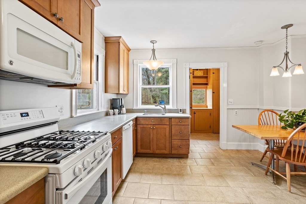 256 Great Road Stow, MA 01775 - Photo 6 of 42 a kitchen with a stove a sink and a refrigerator