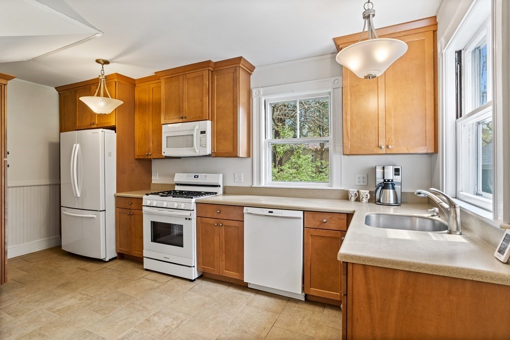256 Great Road Stow, MA 01775 - Photo 7 of 42 a kitchen with stainless steel appliances granite countertop a sink stove and refrigerator