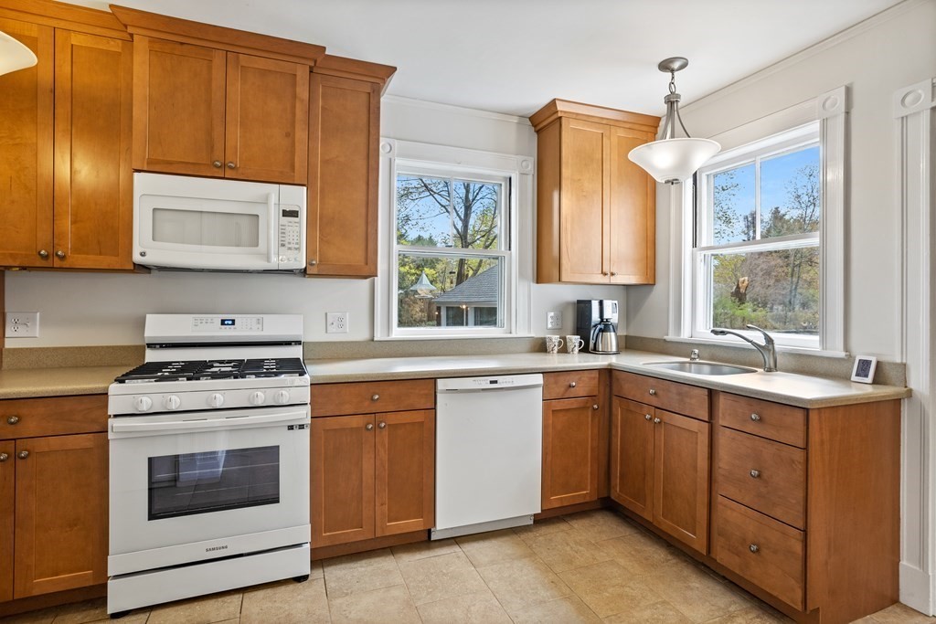 256 Great Road Stow, MA 01775 - Photo 8 of 42 a kitchen with a stove sink and cabinets