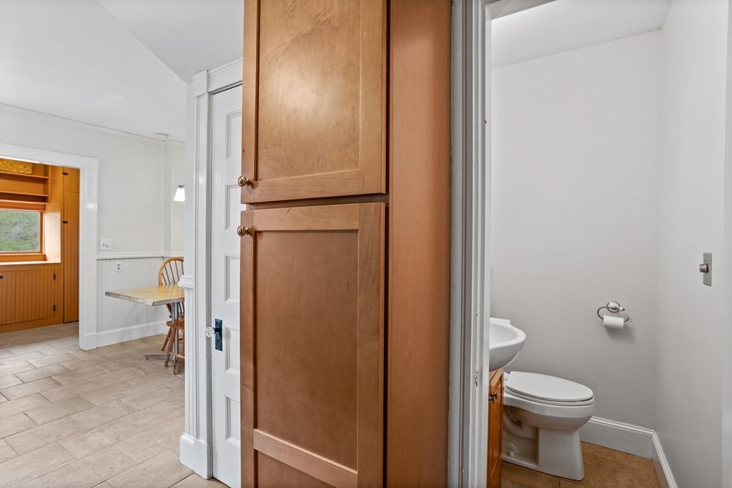 256 Great Road Stow, MA 01775 - Photo 10 of 42 a bathroom with a granite countertop toilet and a sink