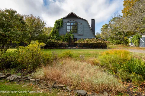 a view of a house with a yard and plants