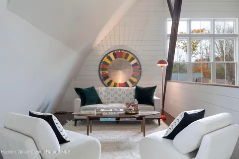 a dining room with furniture and large windows