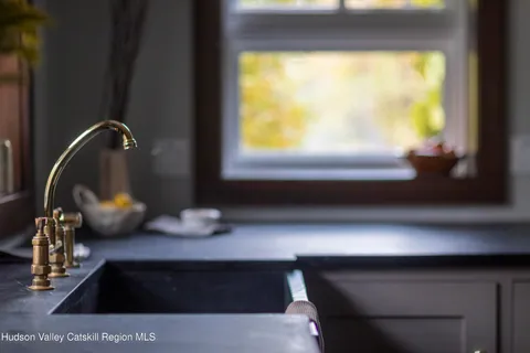 a view of a workspace with furniture and window