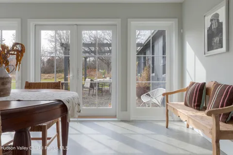 a living room with furniture and a floor to ceiling window