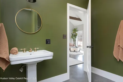 a bathroom with a sink mirror and toilet
