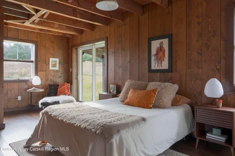 a bedroom with a bed and window
