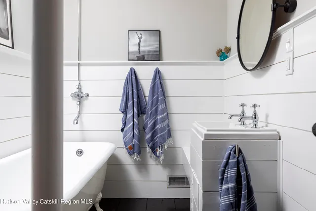 a bathroom with a sink a mirror and a bathtub