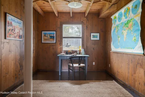 a view of a workspace with furniture and window