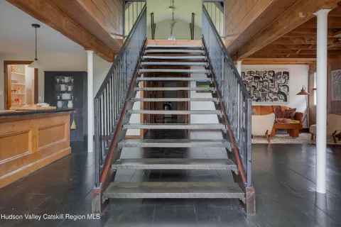 a view of entryway and hall with wooden floor