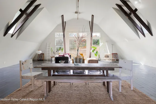 a view of living room with a table and windows
