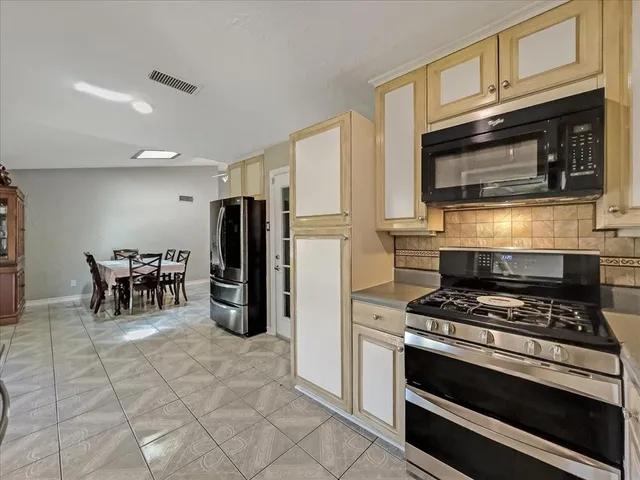 a kitchen with granite countertop a stove and a refrigerator