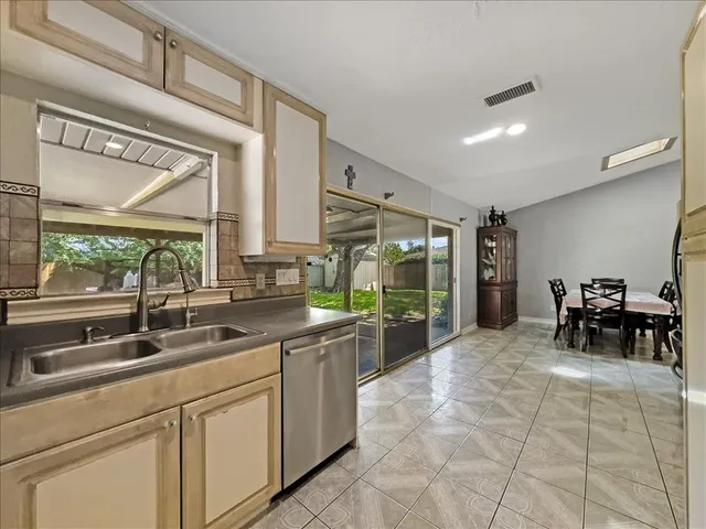 a kitchen with sink cabinets and outdoor view