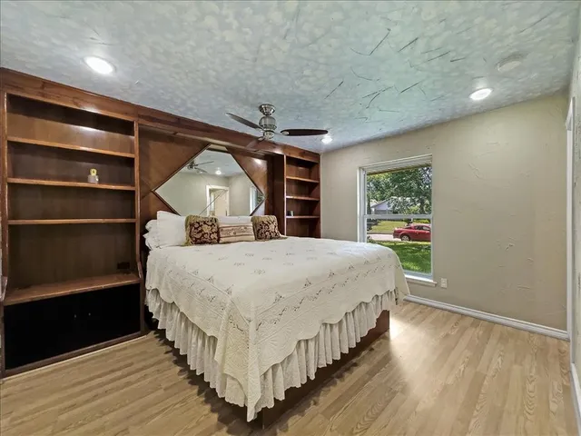 a spacious bedroom with a bed and a window