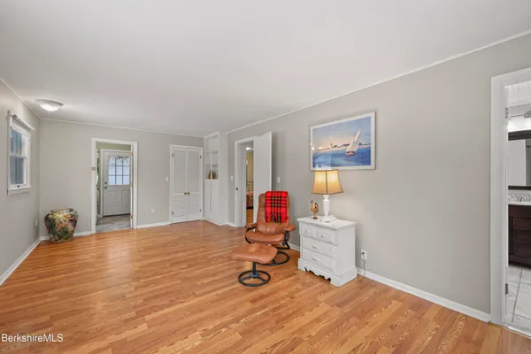 a view of a room with wooden floor and windows